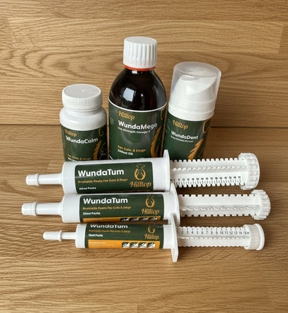 Five Hilltop Pet Food items, including WundaCalm Anxiety Relief for Cats & Dogs, displayed on a wooden surface.