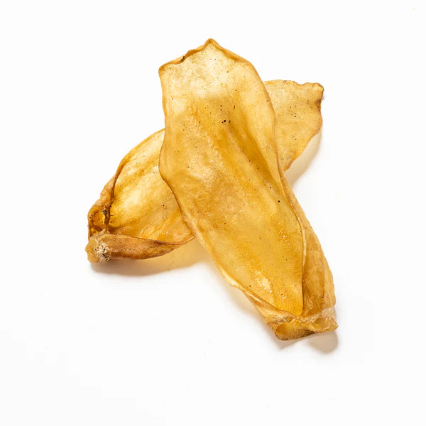 Two small plain goat ears from Hilltop Pet Food overlapping on a white background.